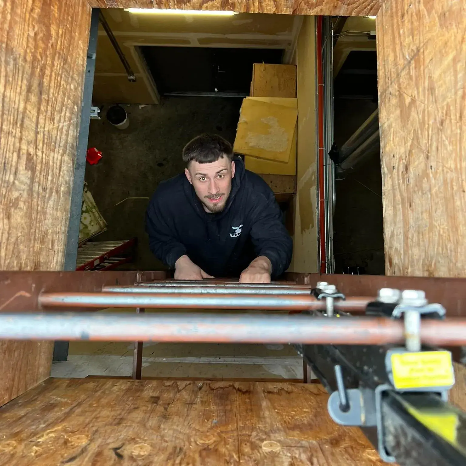 Plumber working on pipes